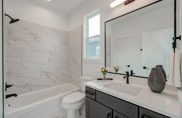 full bathroom featuring toilet, vanity, and tiled shower / bath