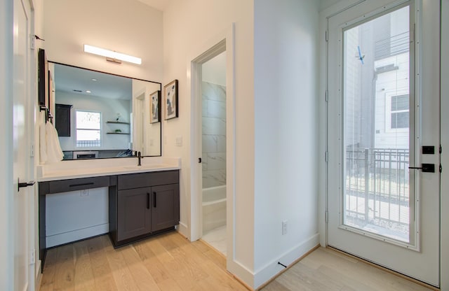 bathroom with vanity, wood-type flooring, and tub / shower combination