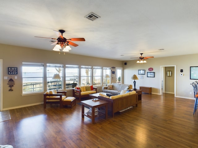 living room featuring ceiling fan and dark hardwood / wood-style floors