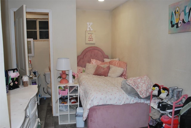 bedroom with dark wood-type flooring