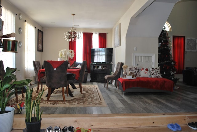 dining area featuring hardwood / wood-style flooring, plenty of natural light, and an inviting chandelier