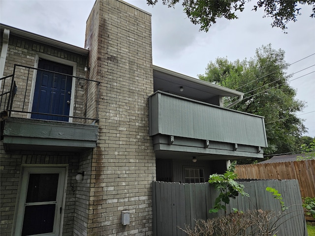 view of side of home with a balcony