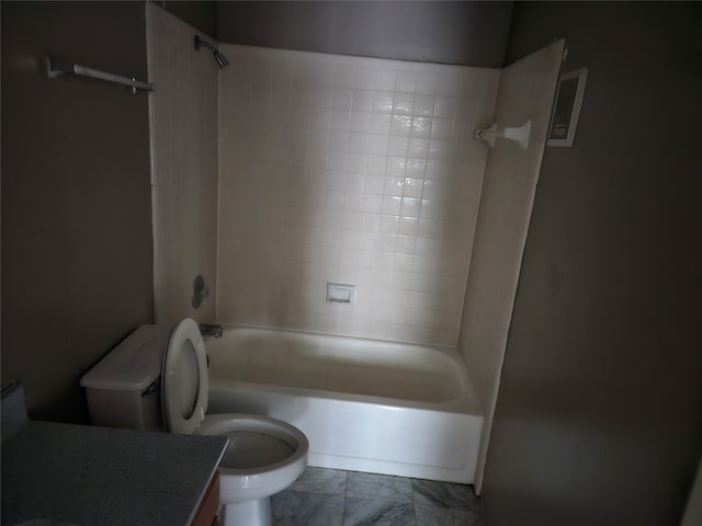 full bathroom with tile patterned floors, tiled shower / bath, toilet, and vanity