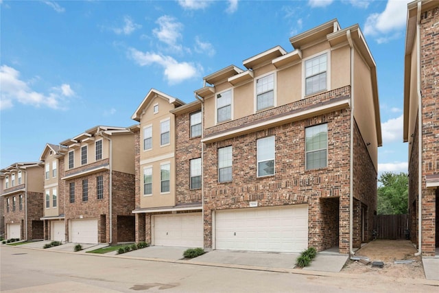 townhome / multi-family property featuring a garage