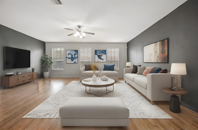 living room with ceiling fan and light hardwood / wood-style flooring