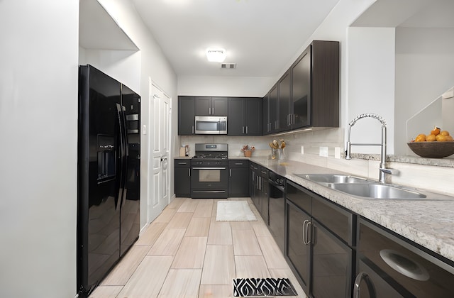 kitchen with black appliances, decorative backsplash, dark brown cabinets, and sink