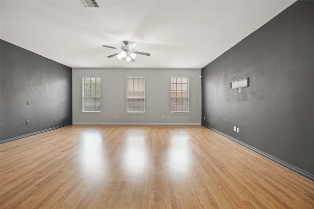 empty room featuring ceiling fan and light wood-type flooring