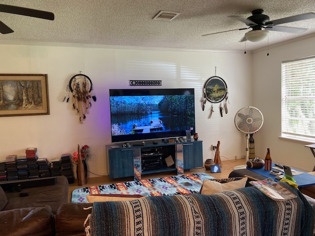 living room featuring a textured ceiling and ceiling fan