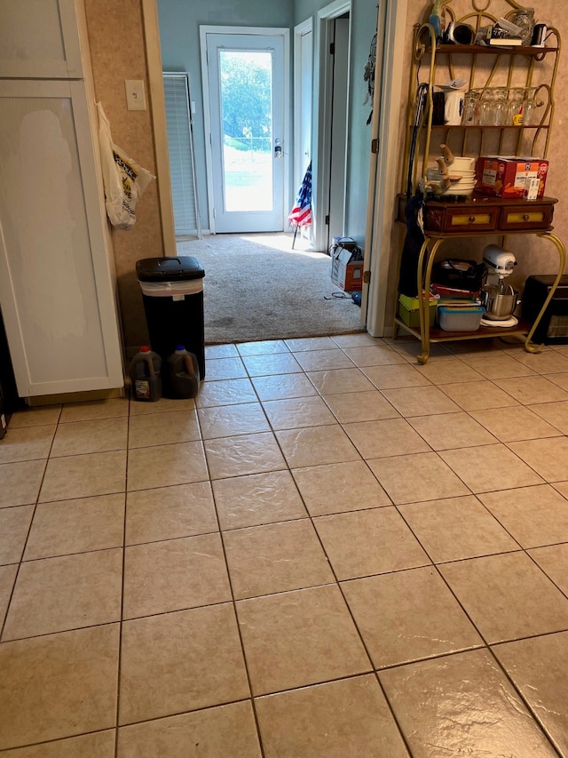 hall featuring light tile patterned floors