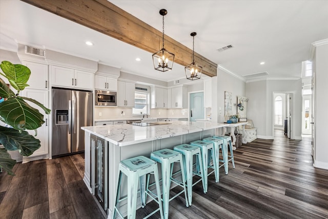 kitchen with stainless steel appliances, white cabinetry, dark hardwood / wood-style floors, and decorative light fixtures