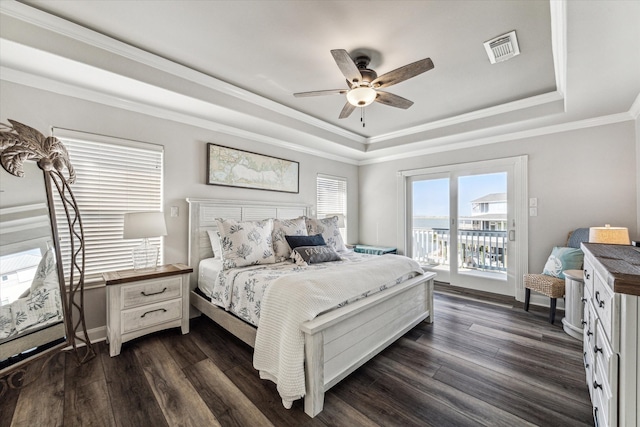 bedroom with ceiling fan, a raised ceiling, access to exterior, and dark wood-type flooring