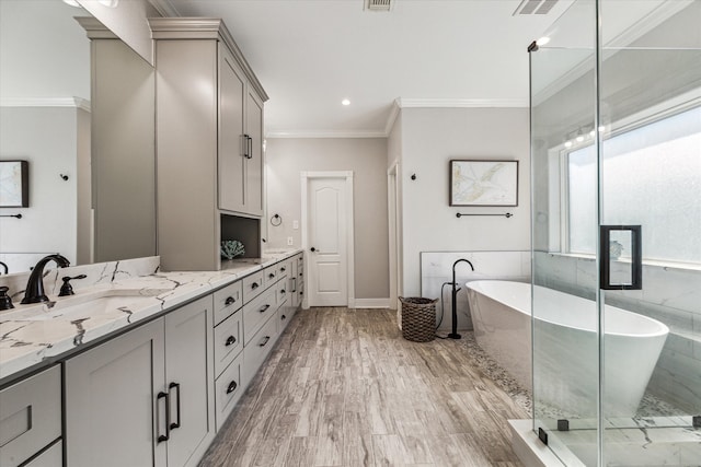 bathroom featuring wood-type flooring, separate shower and tub, vanity, and crown molding