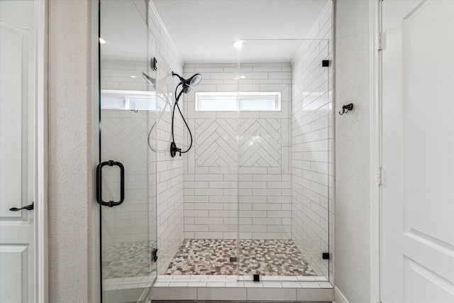 bathroom with a shower with shower door