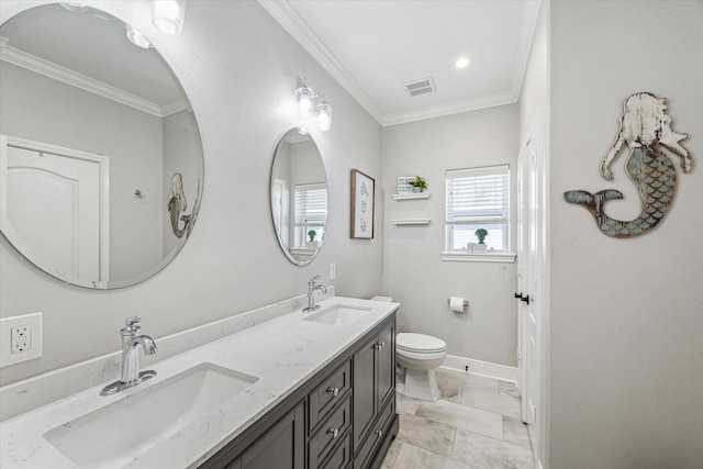 bathroom with ornamental molding, vanity, and toilet