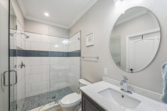 bathroom with vanity, crown molding, toilet, and a shower with door