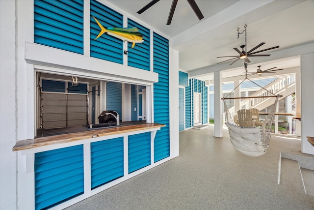 unfurnished sunroom featuring ceiling fan