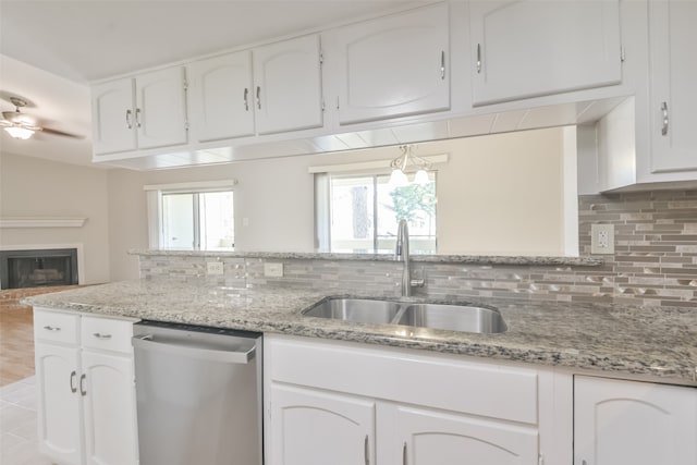 kitchen featuring ceiling fan with notable chandelier, sink, white cabinetry, and stainless steel dishwasher