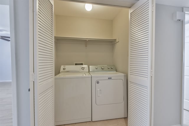 laundry room featuring independent washer and dryer and light tile patterned flooring