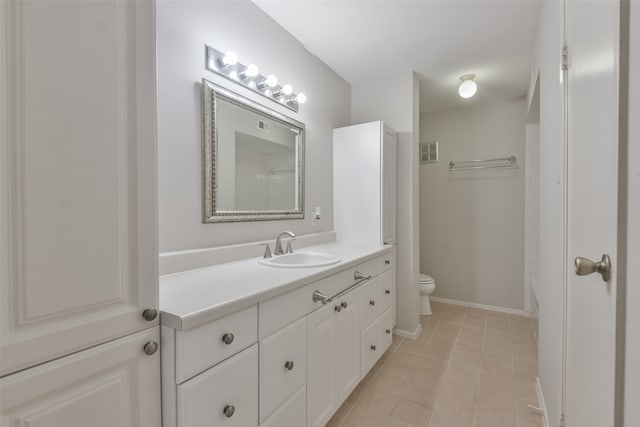 bathroom with vanity, toilet, tile patterned floors, and walk in shower