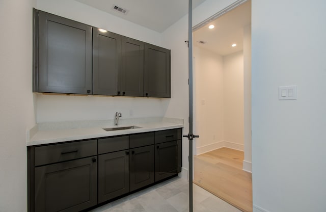 interior space featuring gray cabinetry, sink, and light hardwood / wood-style floors