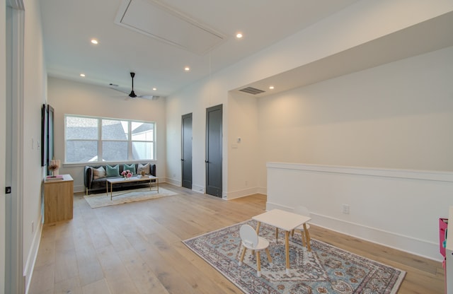 sitting room featuring ceiling fan and light hardwood / wood-style flooring