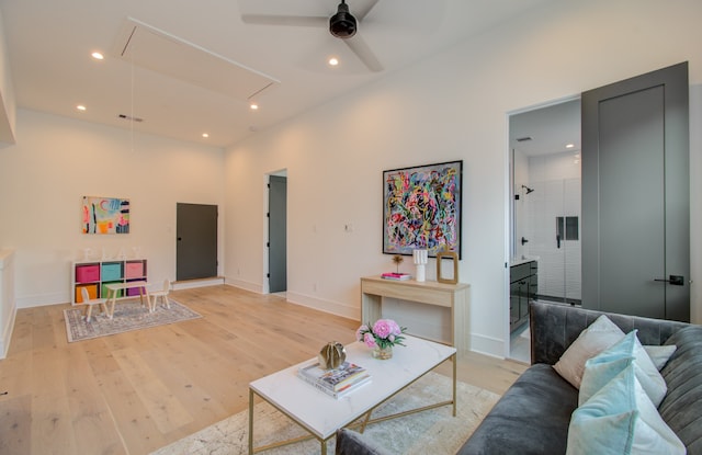 living room with ceiling fan and light hardwood / wood-style floors