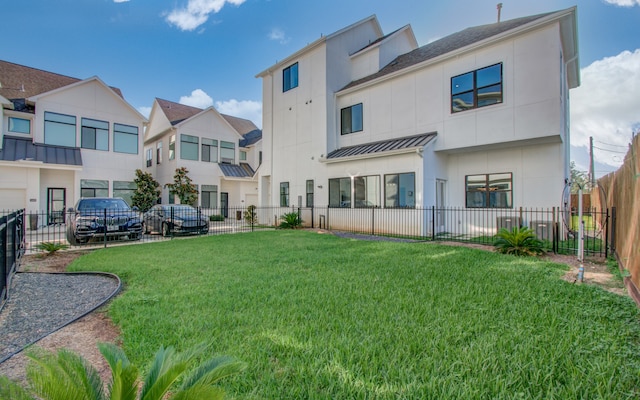 rear view of property featuring a lawn