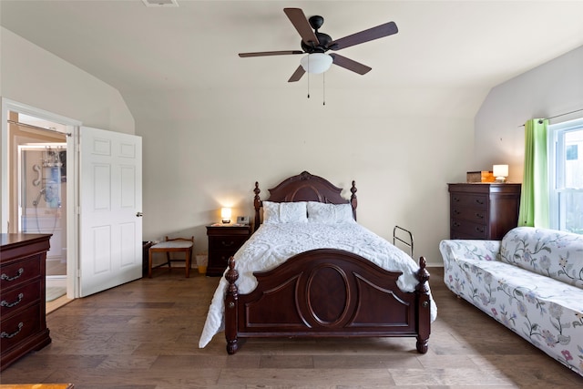 bedroom with ceiling fan, dark wood-type flooring, and lofted ceiling