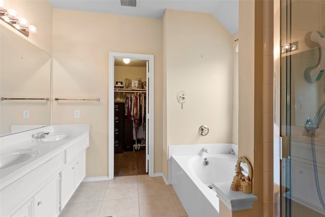 bathroom featuring vanity, tile patterned flooring, plus walk in shower, and lofted ceiling