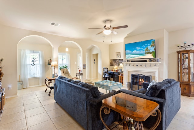 living room with ceiling fan, light tile patterned floors, and a fireplace