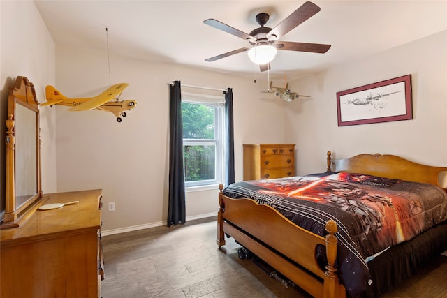 bedroom with ceiling fan and dark hardwood / wood-style floors