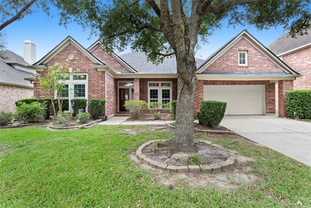 view of front of property with a front yard and a garage