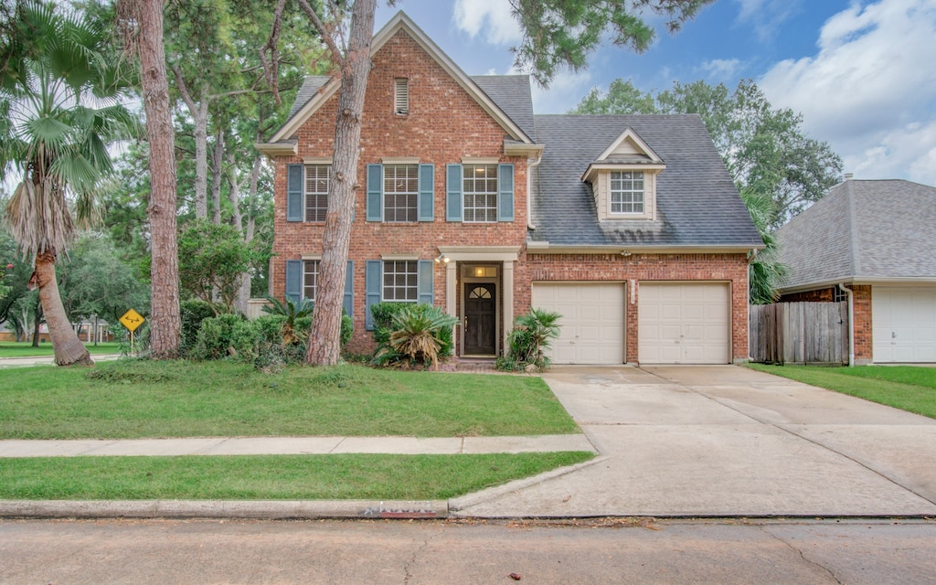 view of front of house featuring a garage and a front lawn