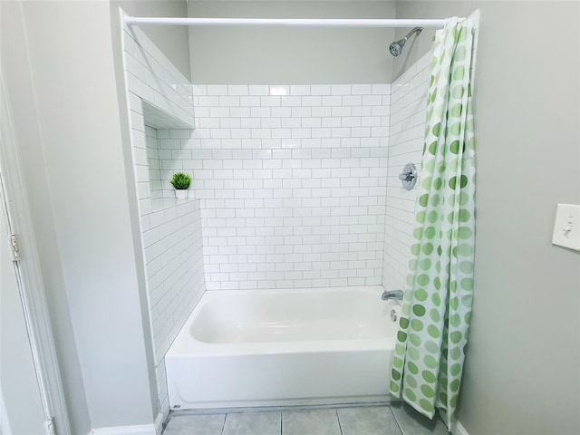 bathroom with tile patterned floors and shower / bath combo