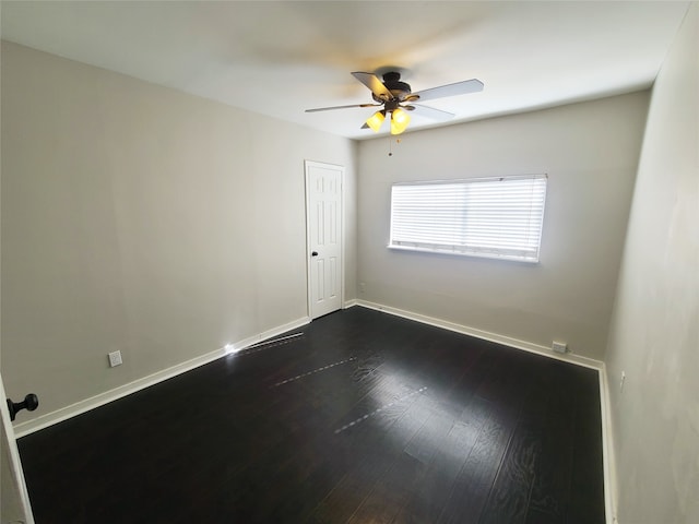 spare room featuring ceiling fan and dark hardwood / wood-style flooring