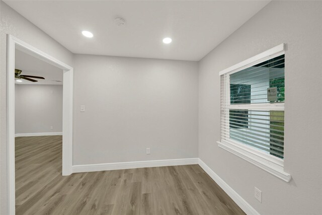 spare room featuring recessed lighting, baseboards, wood finished floors, and a ceiling fan