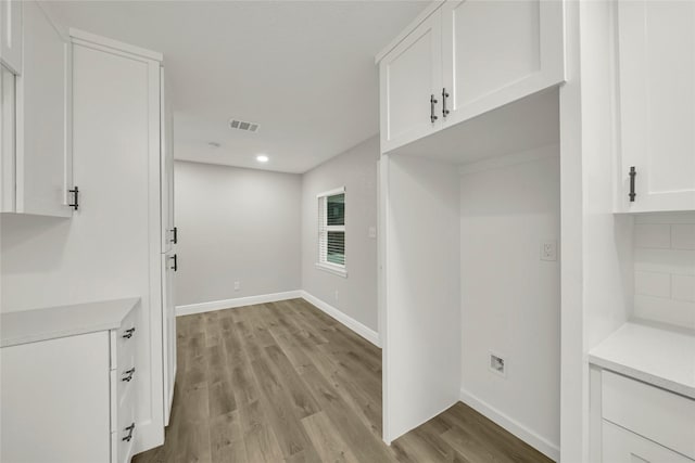 interior space with recessed lighting, baseboards, visible vents, and light wood finished floors