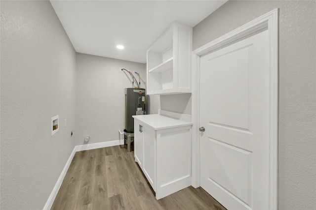 laundry room with electric water heater, baseboards, light wood-type flooring, hookup for a washing machine, and hookup for an electric dryer