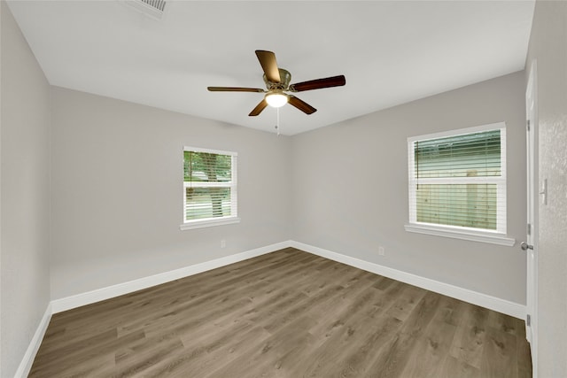 spare room featuring hardwood / wood-style flooring and ceiling fan