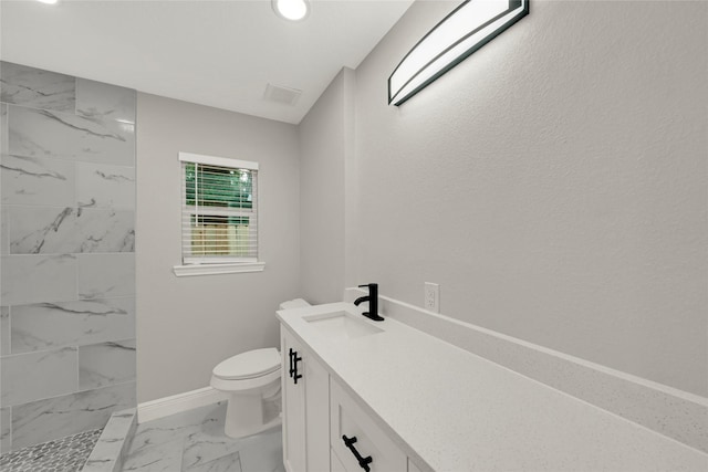 full bathroom with toilet, marble finish floor, tiled shower, baseboards, and vanity