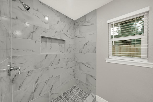 bathroom with a tile shower