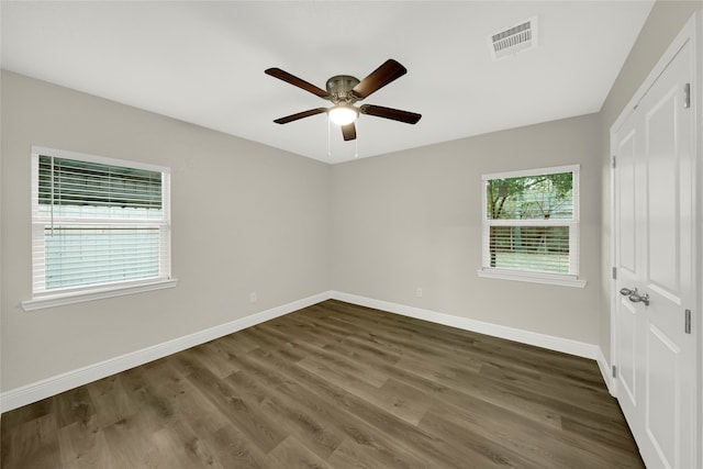 spare room featuring dark hardwood / wood-style flooring and ceiling fan