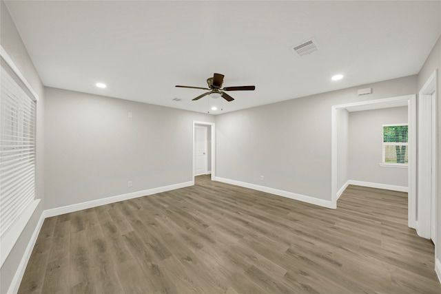 spare room with hardwood / wood-style flooring and ceiling fan