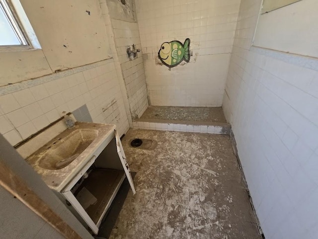 724 Artemediano St, Socorro, TX 79927 - bathroom with tile walls, a tile shower, and vanity
