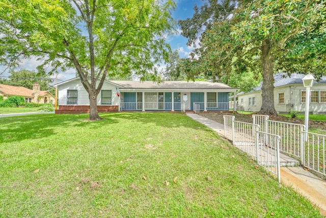 single story home featuring a fenced front yard, a porch, and a front lawn