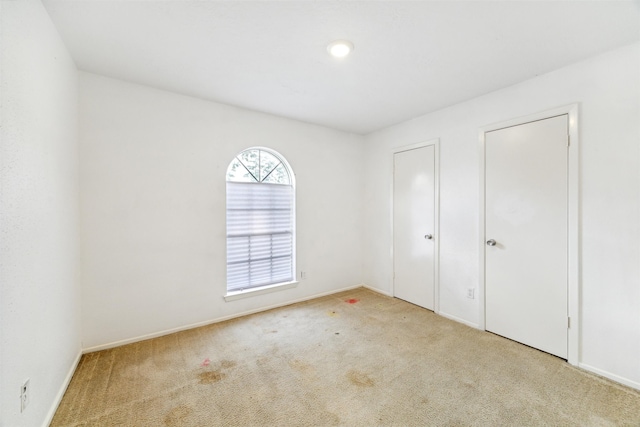 unfurnished bedroom with light carpet