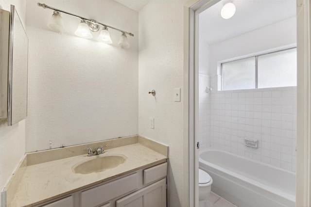 full bathroom featuring vanity, toilet, and tiled shower / bath