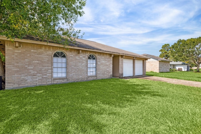 ranch-style house with a garage and a front lawn