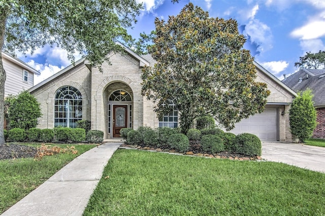 view of front of house with a garage and a front yard