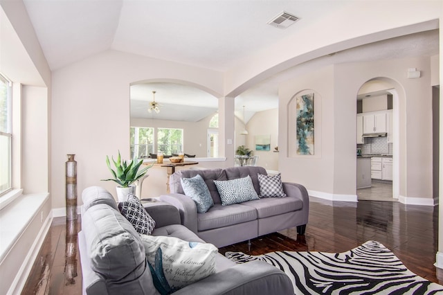 living room featuring lofted ceiling and dark hardwood / wood-style flooring